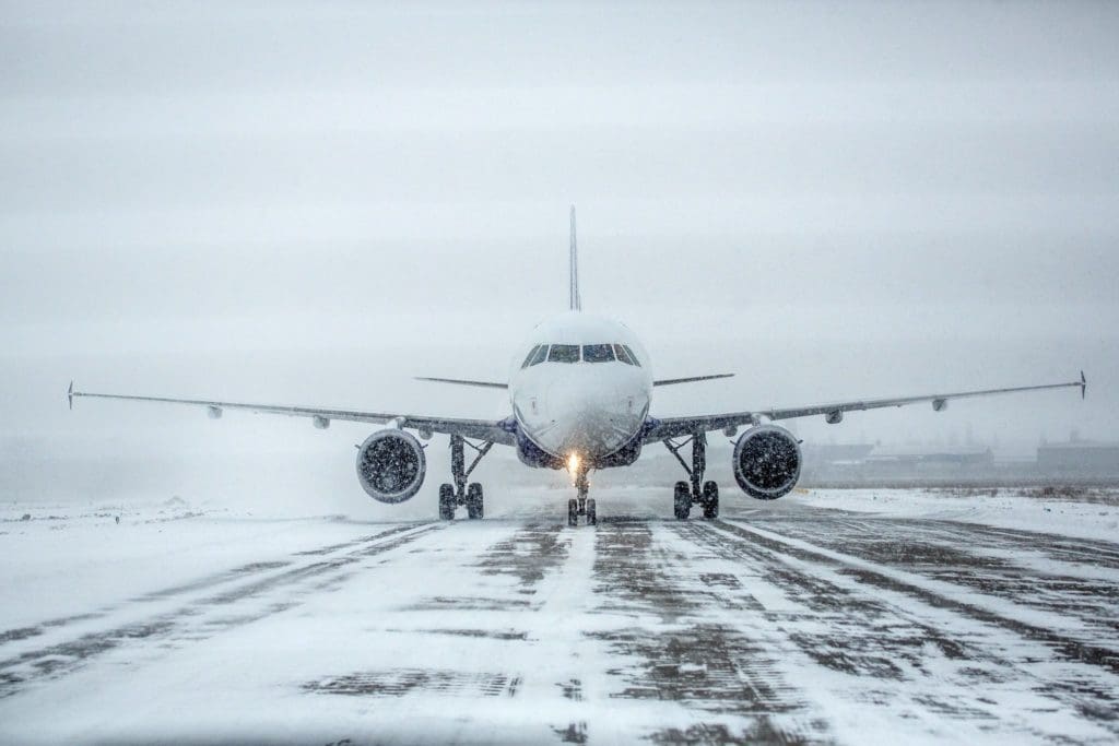 Airplane landing on runway in the snow storm