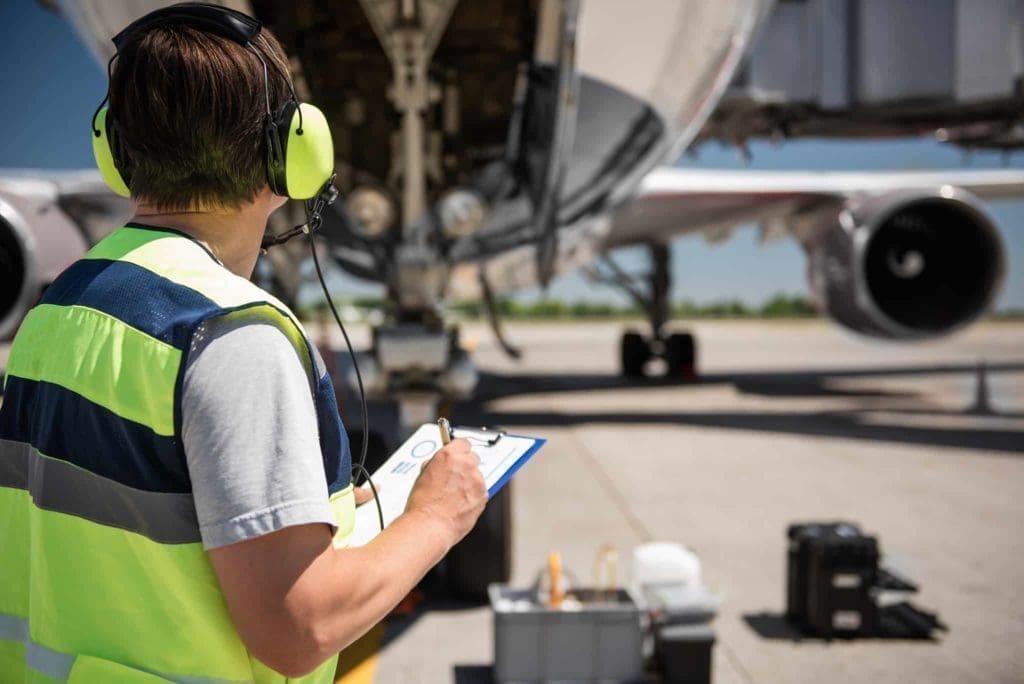 Aircraft technician performing inspectiong